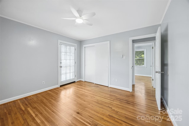 3828 Delgany Dr, Charlotte, NC 28215 - unfurnished bedroom with ornamental molding, baseboards, light wood-style flooring, a closet, and a ceiling fan