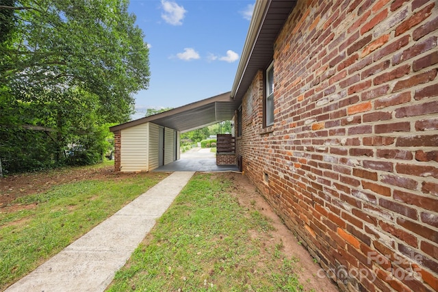 3828 Delgany Dr, Charlotte, NC 28215 - view of side of home featuring brick siding, an attached carport, and a yard