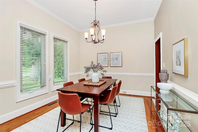 4509 Rosecliff Dr, Charlotte, NC 28277 - dining area with crown molding, wood finished floors, a chandelier, and baseboards