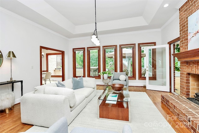 4509 Rosecliff Dr, Charlotte, NC 28277 - living room with a raised ceiling, wood finished floors, a fireplace, ornamental molding, and baseboards