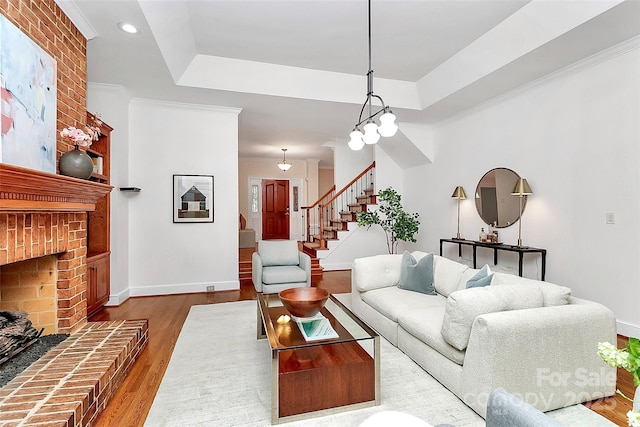4509 Rosecliff Dr, Charlotte, NC 28277 - living room with stairs, a brick fireplace, wood finished floors, baseboards, and recessed lighting