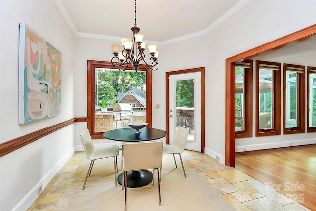 4509 Rosecliff Dr, Charlotte, NC 28277 - dining area with plenty of natural light, stone tile flooring, a chandelier, crown molding, and baseboards