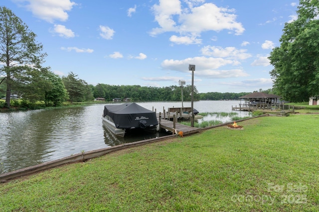 dock area with a water view and a yard