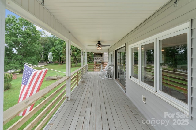 porch featuring a yard and a ceiling fan