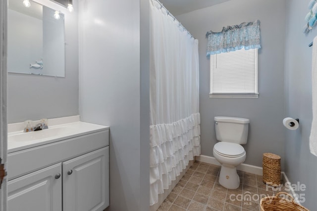 bathroom featuring vanity, toilet, tile patterned flooring, a shower with shower curtain, and baseboards