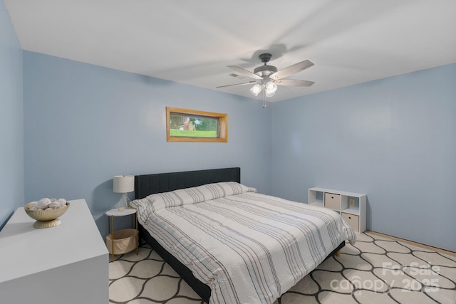 bedroom with a ceiling fan and carpet