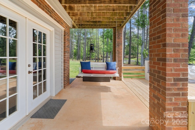 covered porch featuring french doors