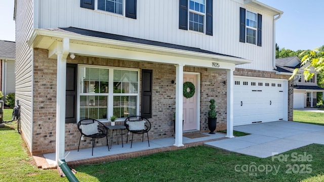 view of front of house featuring a porch, board and batten siding, a front yard, brick siding, and an attached garage