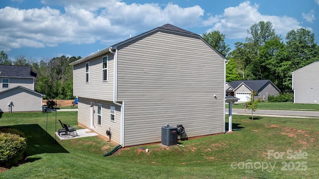 view of side of home featuring a lawn, a patio, and cooling unit