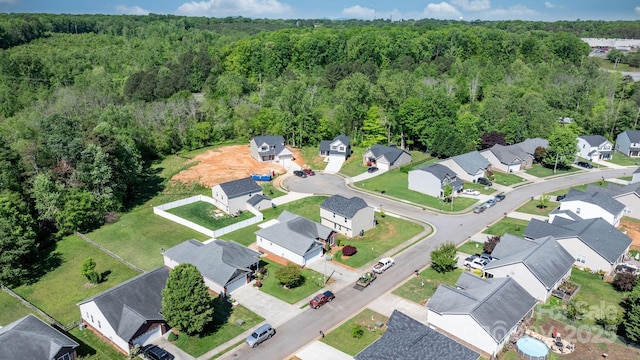 bird's eye view featuring a view of trees and a residential view