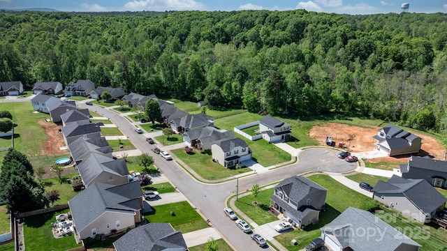 bird's eye view featuring a forest view and a residential view