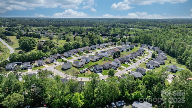 birds eye view of property featuring a view of trees and a residential view