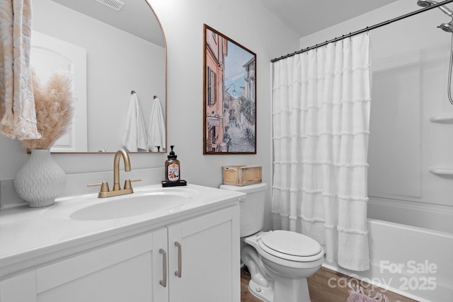 bathroom featuring toilet, shower / bath combination with curtain, wood finished floors, and vanity