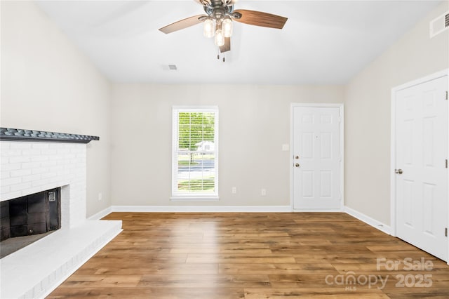 unfurnished living room with visible vents, baseboards, ceiling fan, and wood finished floors
