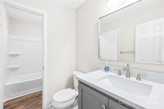 full bathroom featuring shower / bath combination, vanity, toilet, and wood finished floors