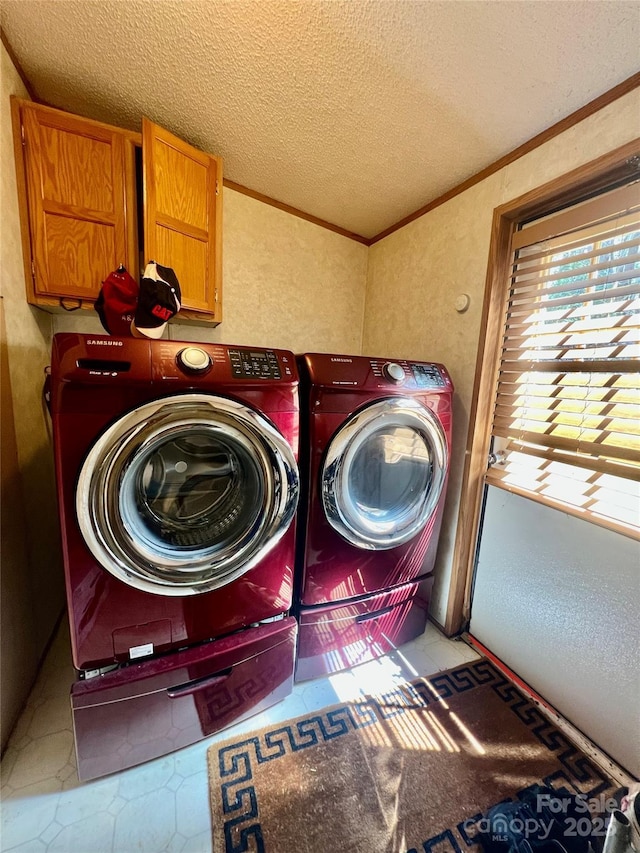 343 Daytona Ln, Saluda, NC 28773 - laundry room with cabinet space, independent washer and dryer, a textured wall, a textured ceiling, and ornamental molding