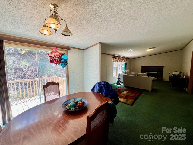 343 Daytona Ln, Saluda, NC 28773 - carpeted dining space featuring ornamental molding, a fireplace, and a textured ceiling