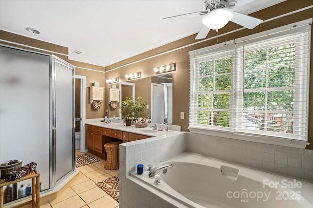full bathroom featuring a ceiling fan, a sink, a bath, a shower stall, and tile patterned floors