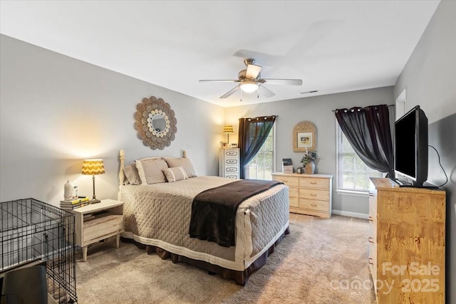 bedroom featuring a ceiling fan, light carpet, visible vents, and baseboards