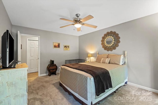 carpeted bedroom featuring baseboards and ceiling fan