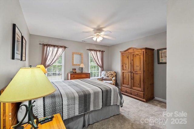 carpeted bedroom with baseboards and a ceiling fan