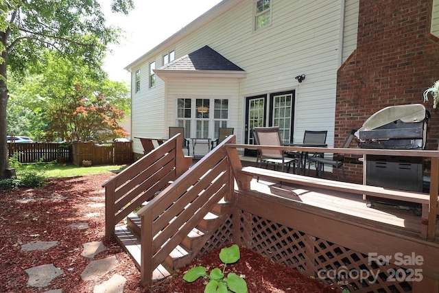deck featuring fence and outdoor dining space