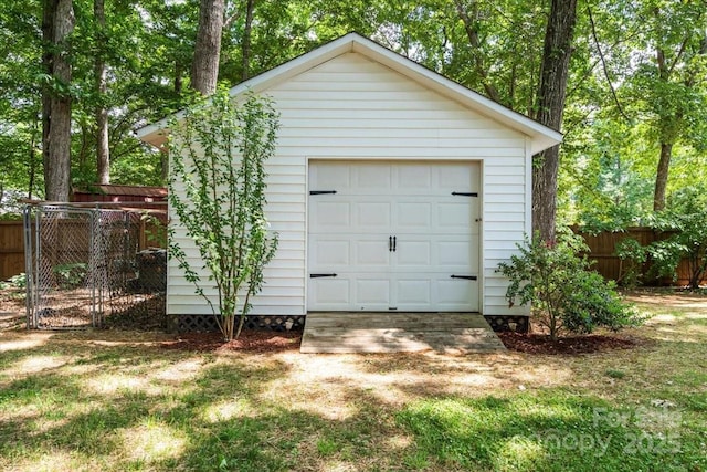 detached garage featuring fence
