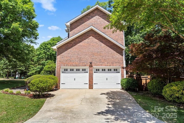 view of home's exterior featuring concrete driveway, brick siding, fence, and an attached garage