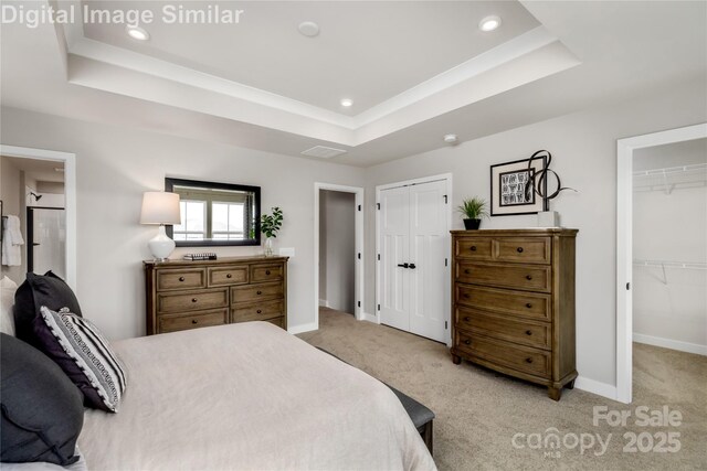 bedroom featuring visible vents, baseboards, light colored carpet, recessed lighting, and a tray ceiling