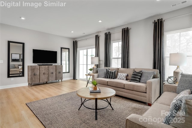 living area featuring visible vents, recessed lighting, and light wood finished floors