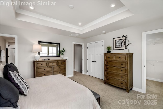 bedroom featuring visible vents, baseboards, light colored carpet, recessed lighting, and a tray ceiling