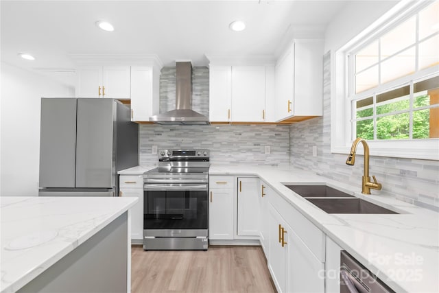 662 Camp Ferry Rd, Mooresboro, NC 28114 - kitchen featuring wall chimney exhaust hood, stainless steel appliances, a sink, white cabinets, and light wood-style floors