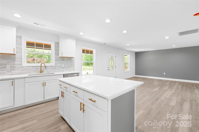 662 Camp Ferry Rd, Mooresboro, NC 28114 - kitchen featuring a sink, light wood finished floors, tasteful backsplash, recessed lighting, and white cabinets
