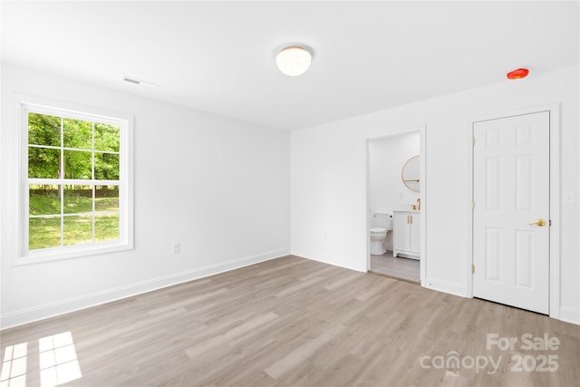 662 Camp Ferry Rd, Mooresboro, NC 28114 - unfurnished bedroom with wood finished floors, baseboards, and ensuite bath