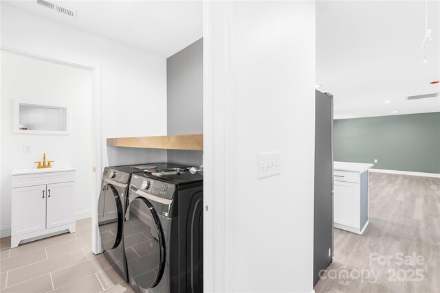 662 Camp Ferry Rd, Mooresboro, NC 28114 - clothes washing area featuring independent washer and dryer, baseboards, and cabinet space