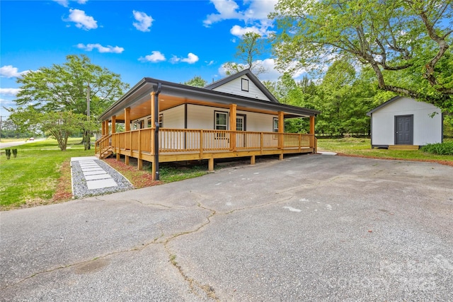 662 Camp Ferry Rd, Mooresboro, NC 28114 - farmhouse with covered porch, a storage unit, an outdoor structure, and a front yard