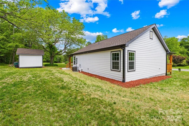 662 Camp Ferry Rd, Mooresboro, NC 28114 - view of home's exterior featuring central AC, a storage shed, an outdoor structure, and a lawn