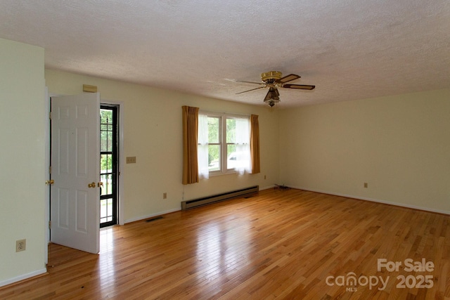 80 Beech Glen Dr, Black Mountain, NC 28711 - spare room with ceiling fan, a textured ceiling, visible vents, baseboard heating, and light wood-style flooring