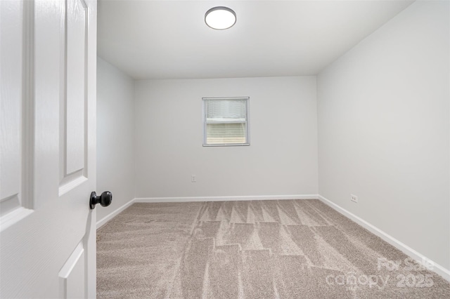 empty room with carpet floors and baseboards