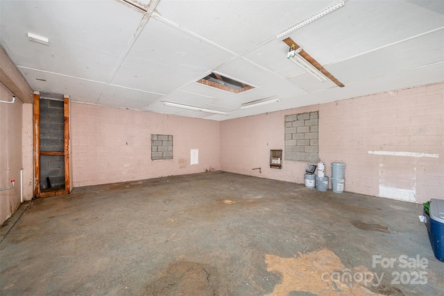 1211 N Boyce St, Gastonia, NC 28052 - spare room featuring unfinished concrete flooring and concrete block wall