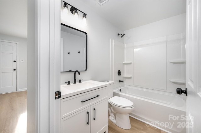 1211 N Boyce St, Gastonia, NC 28052 - full bath with wood finished floors, vanity, tub / shower combination, and toilet