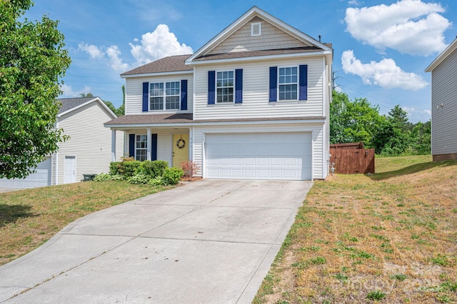 traditional home with fence, a shingled roof, a garage, a front yard, and driveway