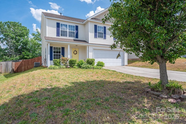 traditional-style house featuring fence, an attached garage, a front lawn, central AC unit, and driveway
