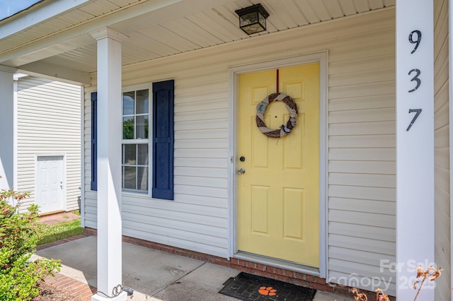 doorway to property featuring covered porch
