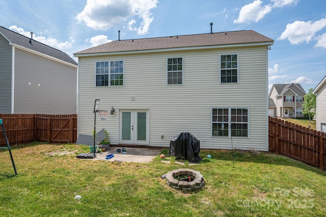 back of house featuring french doors, a fenced backyard, a patio area, and an outdoor fire pit