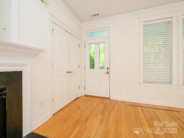 entrance foyer featuring baseboards, light wood-type flooring, and visible vents