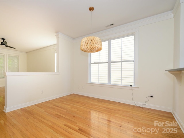 unfurnished dining area with visible vents, baseboards, and hardwood / wood-style floors