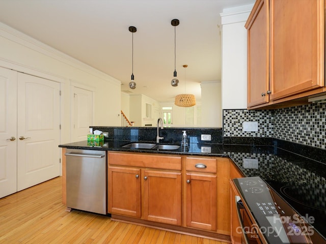 kitchen featuring dishwasher, stove, a sink, a peninsula, and light wood-type flooring