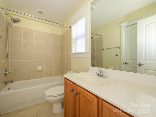bathroom featuring toilet, tile patterned floors, vanity, and bathing tub / shower combination
