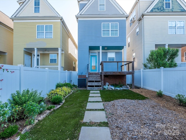 rear view of house with a porch and a fenced backyard